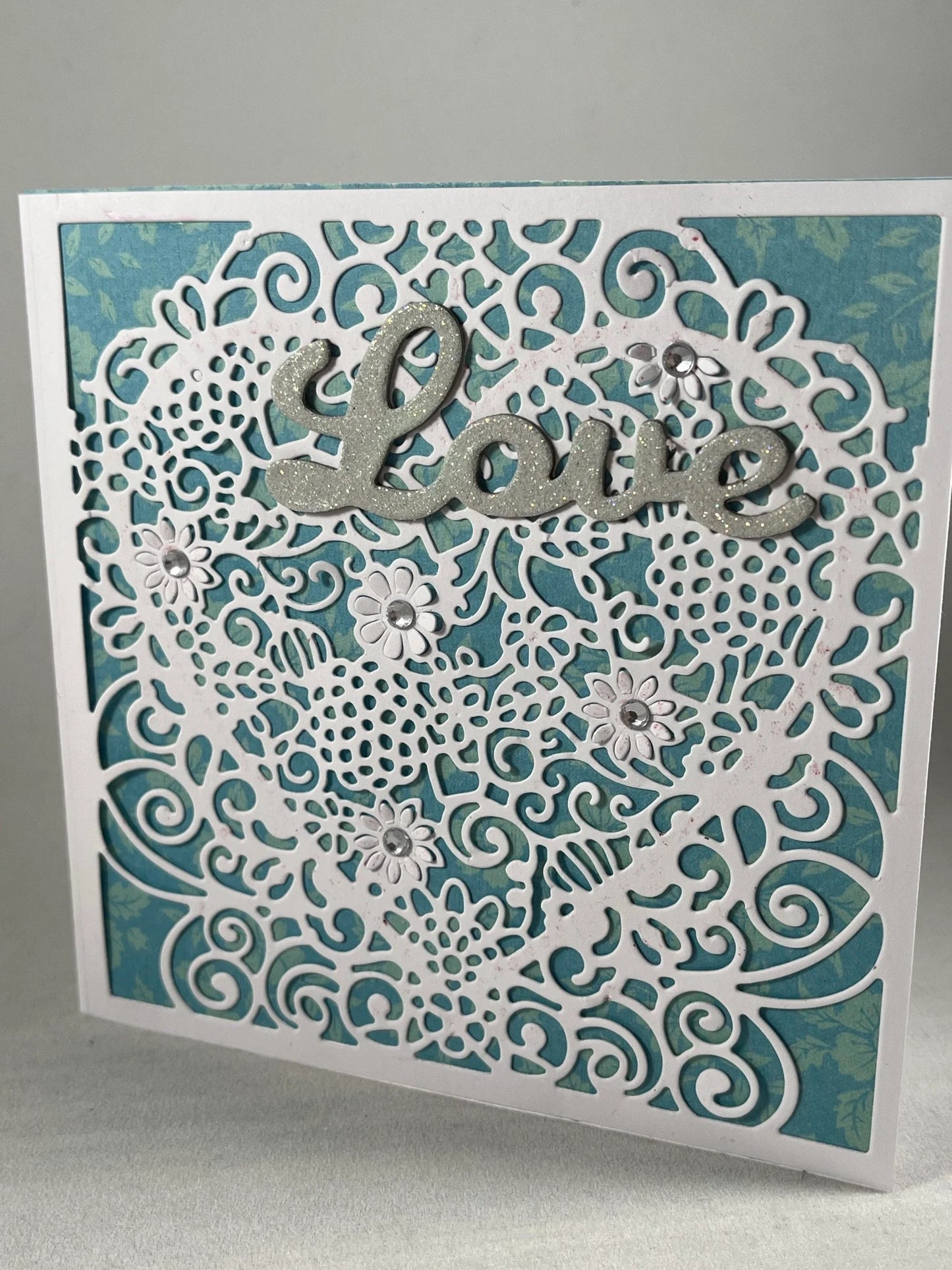Filigree lace heart with glittered sentiment makes this handmade card stand out!