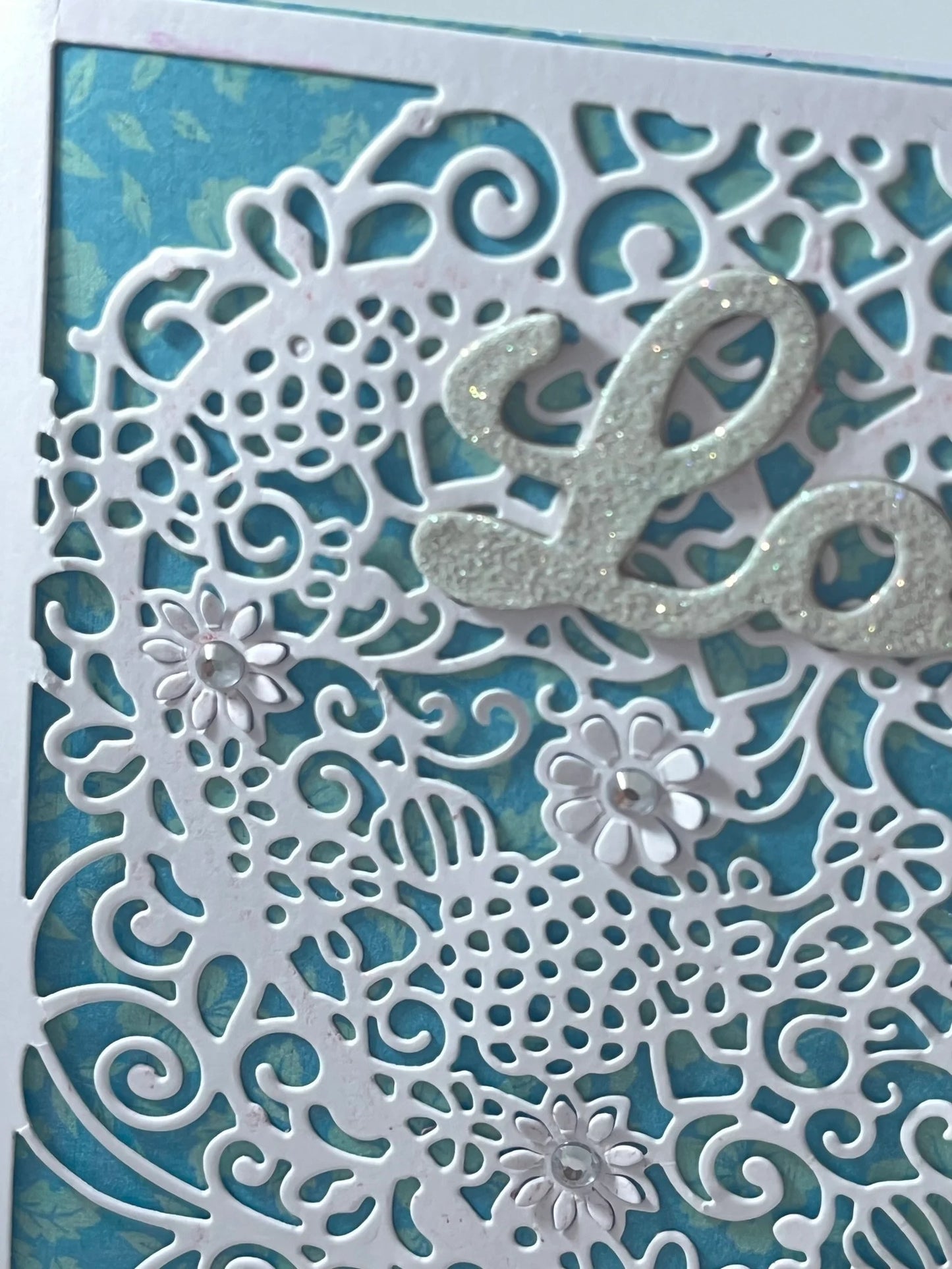 Filigree lace heart with glittered sentiment makes this handmade card stand out!