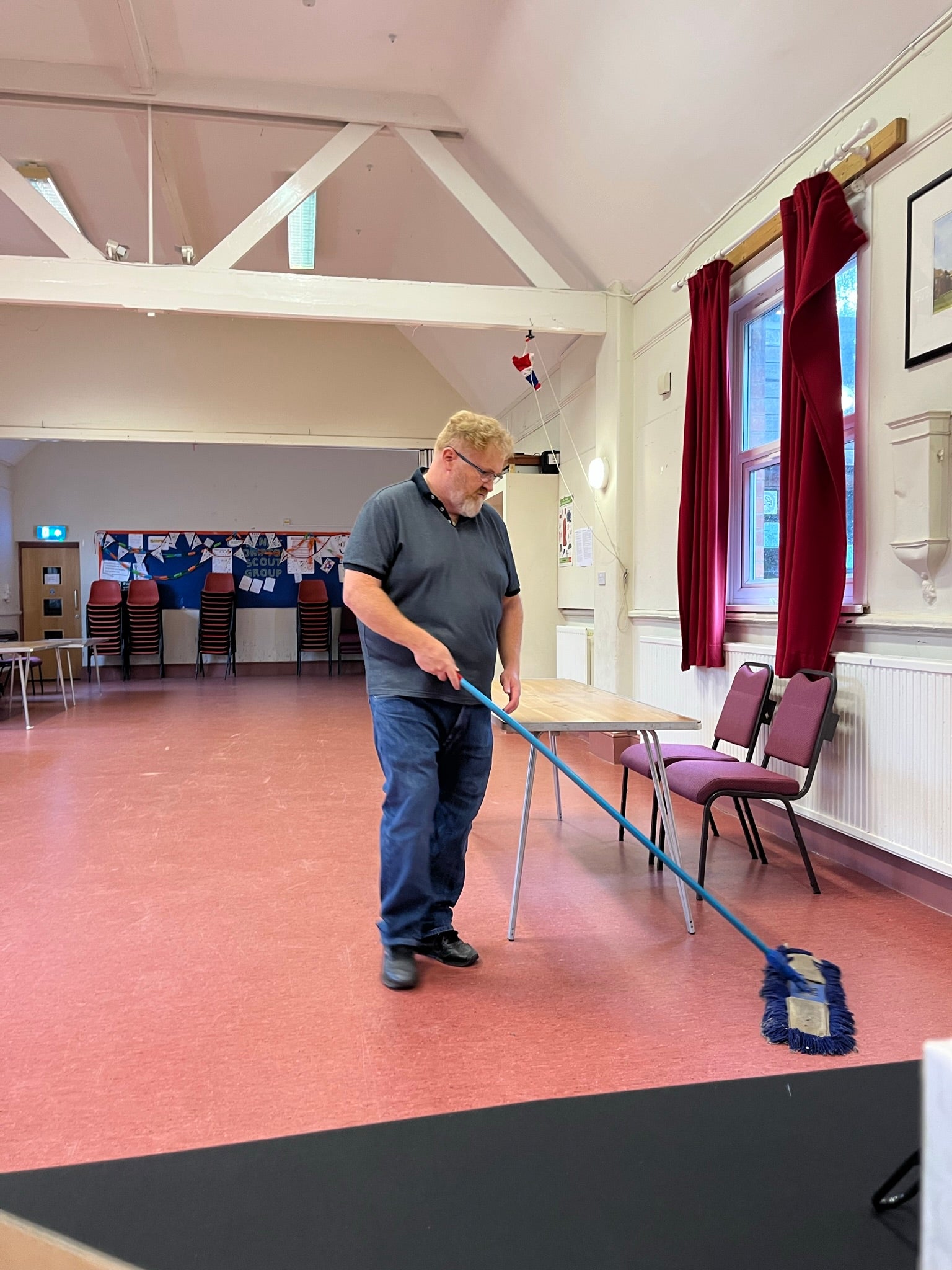 Even my hubby gets involved - a tall stocky ginger bearded man mopping the floor after putting all the tables away when the craft fair finished

