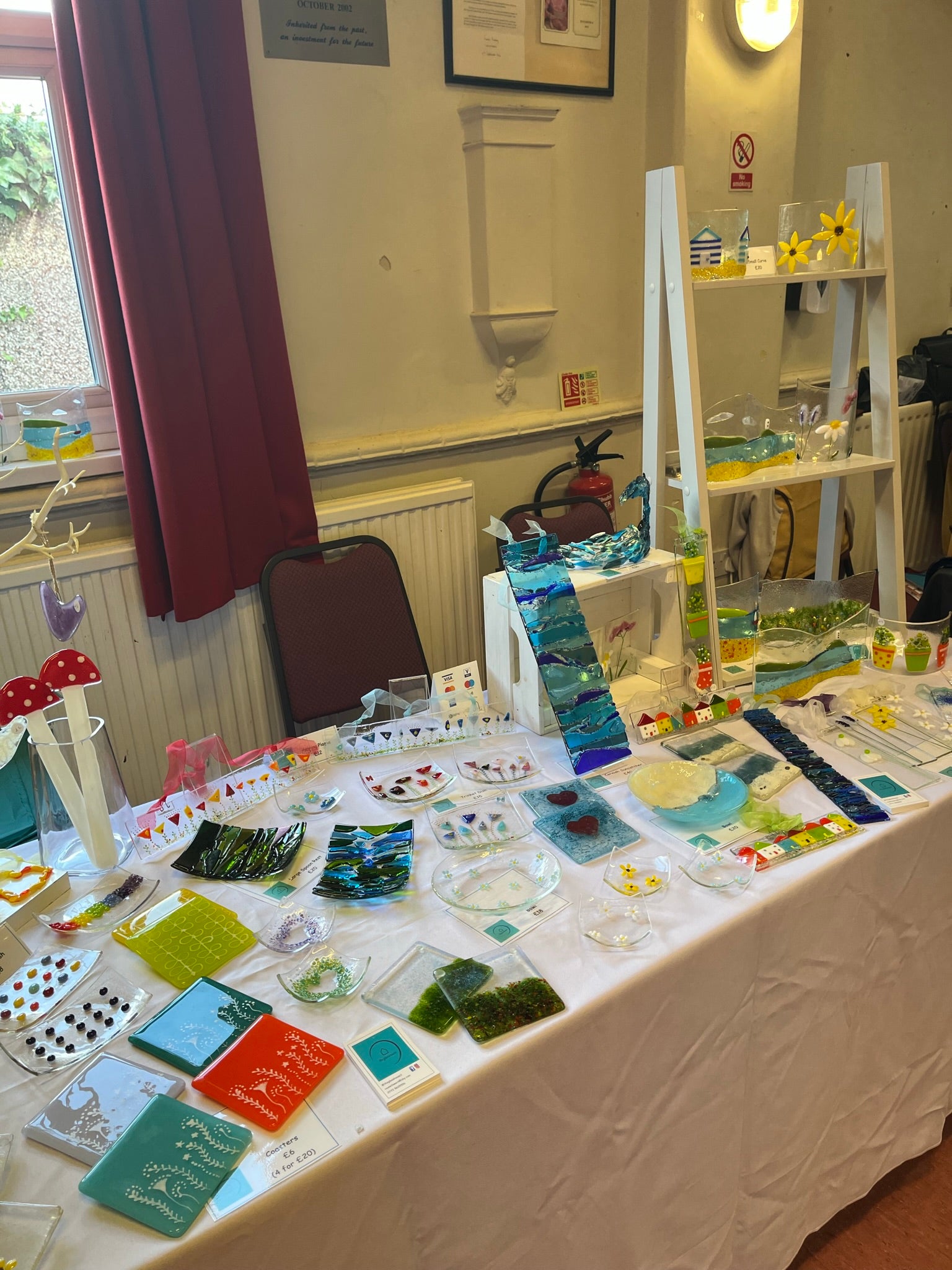 Table with gorgeous fused glass art pieces by a local artisan
