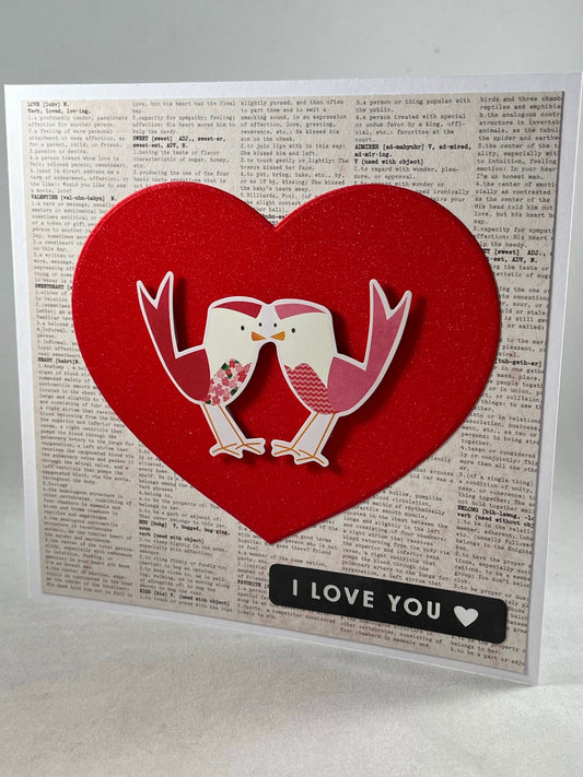Two little lovebirds sitting in a tree... Kissing... Spread some love with these cute birdies on gorgeous glitter card