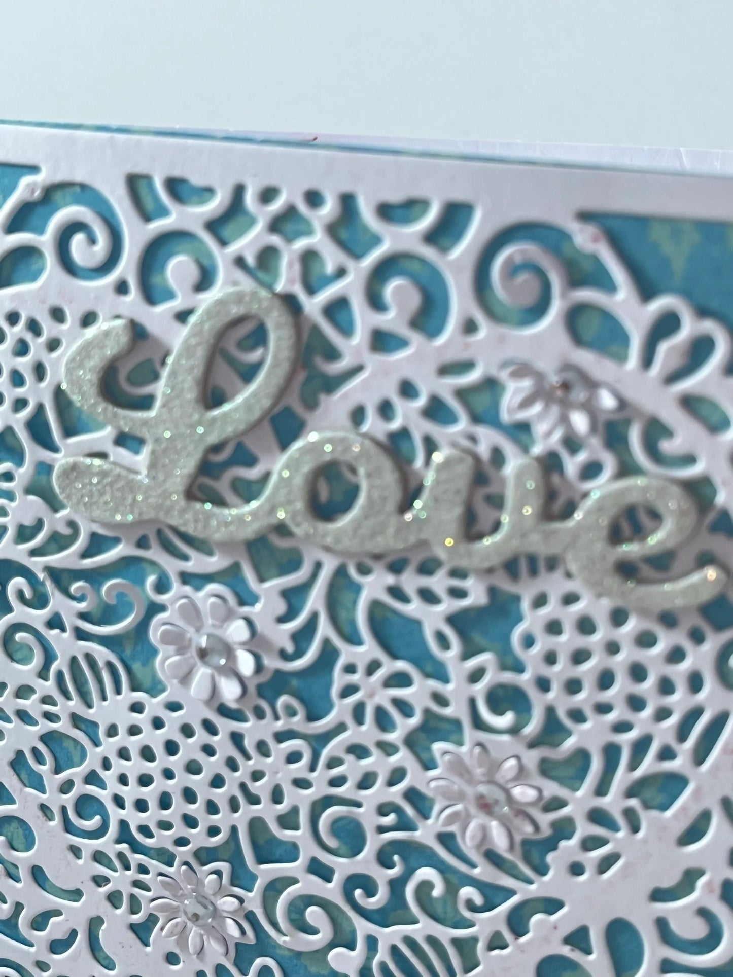 Filigree lace heart with glittered sentiment makes this handmade card stand out!